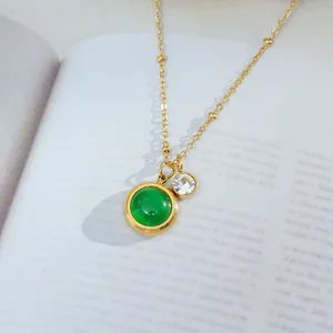 Elegant gold titanium necklace with a green cat-eye stone and a sparkling zircon pendant