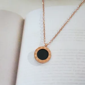 Rose gold titanium necklace featuring a round Roman numeral pendant with black enamel