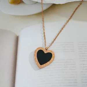 Elegant rose gold heart necklace with black enamel inlay and Roman numeral engravings