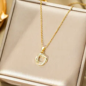 Detailed close-up of golden interlocking rings pendant with zircon micro-pave setting