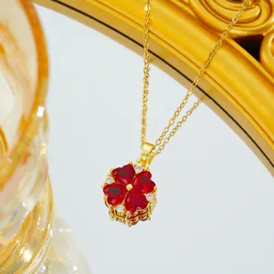 Macro shot of gold necklace with red heart-shaped clovers and sparkling zircon stones