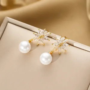 Elegant gold flower pearl drop earrings with sparkling zircon stones on luxury silk base