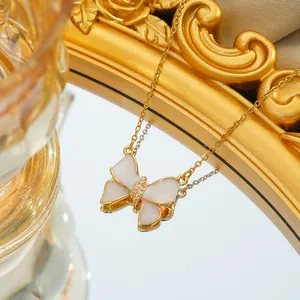 Elegant gold titanium steel bow necklace with white enamel inlay and sparkling crystals