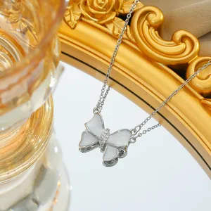 Macro shot of titanium steel bow necklace with pearlescent finish and zircon detail