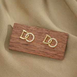 Elegant gold titanium steel D-letter stud earrings with geometric zircon circles