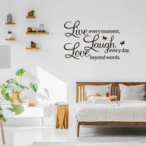 Detail of 'Live Love Laugh' wall decal with elegant cursive font and butterfly accents