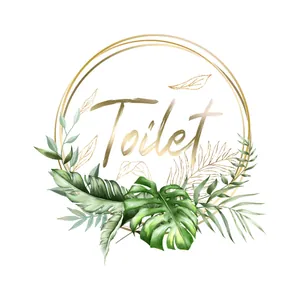 Macro detail of a tropical leaf toilet wall sticker with gold lettering and monstera leaves