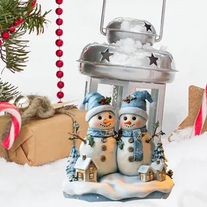 Detail of light-up Christmas snowmen figures with blue hats on a snowy winter base