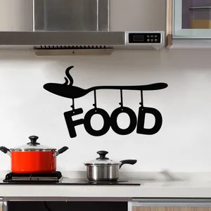 Close-up of black 'FOOD' wall sticker with spoon silhouette in modern kitchen decor