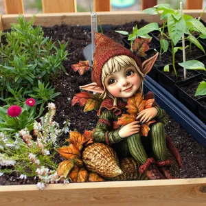 Detail of garden gnome fairy stake with maple leaf in an autumn garden setting