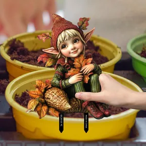 Macro detail of autumn gnome garden stake with leaf hat and green striped outfit