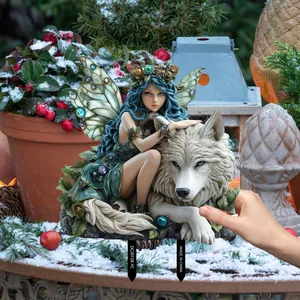 Garden stake detail showing a blue-haired fairy leaning on a majestic white wolf in snow