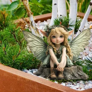 Exquisite garden fairy statue with golden hair and green dress sitting on wooden base