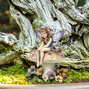 Garden fairy figurine sitting on a mushroom with butterflies in a forest setting