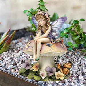 Close-up detail of a fairy figurine sitting on a mushroom in a garden micro-landscape
