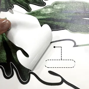 Detailed macro shot of peel-and-stick green plant wall decal showing adhesive quality