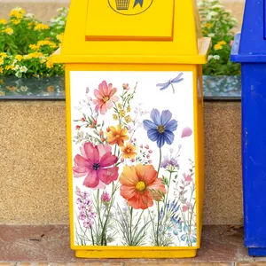 Detail of waterproof watercolor flower and dragonfly stickers on a yellow waste bin