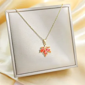 Exquisite 18K gold plated maple leaf necklace with red zircons in a jewelry gift box