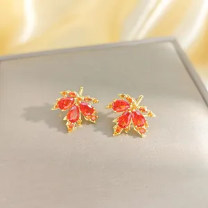 Elegant 18K gold-plated red maple leaf earrings with sparkling zircon gemstones