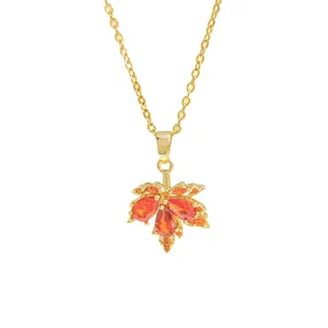Sparkling maple leaf pendant necklace in 18K gold plated copper with red zircon stones