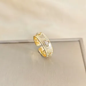 Vintage gold open ring featuring brushed texture and clover hollow floral pattern