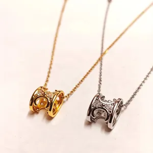 Elegant gold and silver H-letter necklaces with crystal-encrusted pavé cylinder pendants