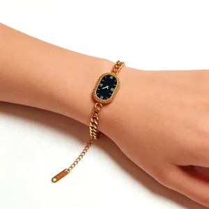Elegant gold chain watch for women with oval black dial and Greek key pattern