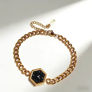 Macro detail of gold stainless steel bracelet with hexagonal dial pendant and clasp