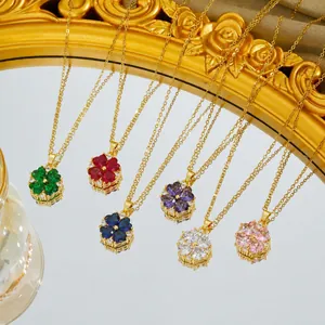 Detailed macro view of colorful enamel flower clover pendants on gold-plated necklaces