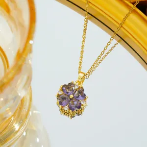 Golden titanium clover necklace featuring four purple heart zircons and bright white accents
