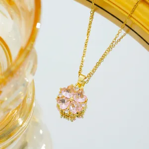 Pink heart clover necklace in gold plating with crystal pendant on mirror surface