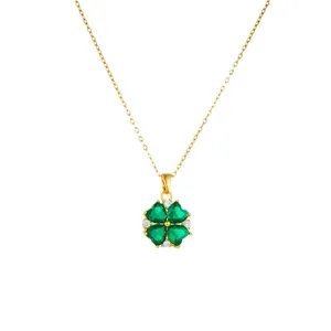 Gold necklace with green heart-shaped gemstones clover pendant and sparkling zircons