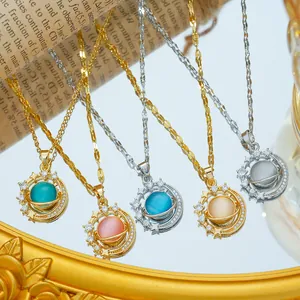 Starry sky saturn necklace with cat eye stone and cubic zirconia on vintage newspaper