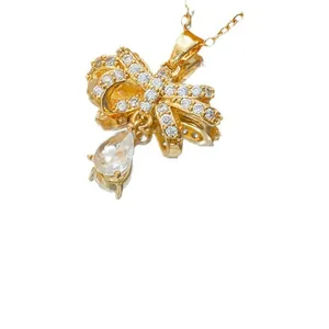 Funkelndes Schmuckset mit goldenem Schleifenanhänger und Zirkonia in Tropfenschliff