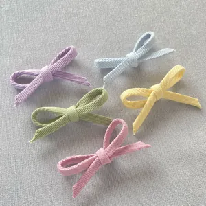 Macro shot of handmade cotton bow tie accessories in five macaron pastel colors