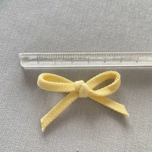 Handmade yellow fabric bow accessory for DIY hair clips and clothing decoration