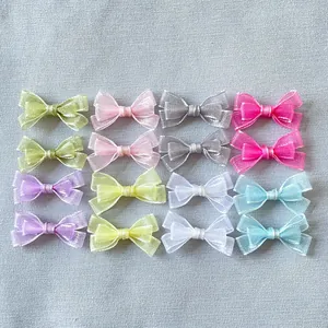 Detailed flat lay of 16 mini organza bows in 8 colors for DIY crafts and pet accessories