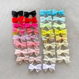 Detailed view of colorful DIY mesh bow accessories for dolls and shoes organized by color