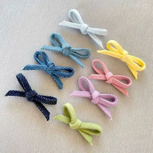 Detail of 8 colorful textured fabric bows for DIY hair accessories and craft projects