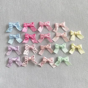 Flat lay of colorful polka dot and solid satin bow DIY craft accessories for hair and clothing