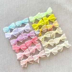 Flat lay of colorful DIY mesh bow accessories for hairpins and doll clothes decoration