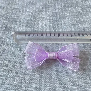 Macro shot of 5cm purple double-layer mesh bow decoration on a measuring ruler