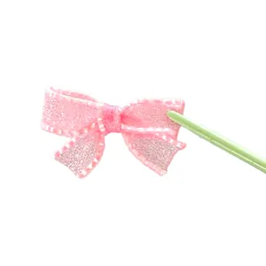 Close-up of pink mesh bow accessory for DIY crafts and doll clothing decoration