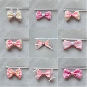 Detail view of nine assorted plaid and lace mesh bow accessories for hairpins and DIY crafts