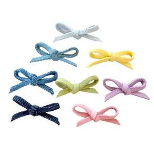 Eight colorful handmade fabric bow accessories for DIY hair clips and crafts in various colors