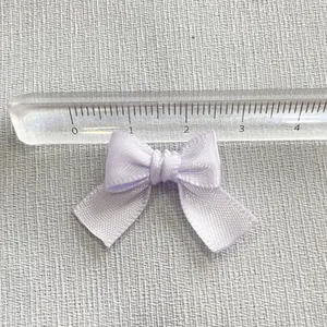Close-up of a lavender satin DIY bow accessory measuring 3cm for hair clip and garment crafts