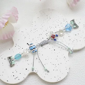 Detail of blue beaded watch strap with ceramic rabbit charm and heart beads for Apple Watch