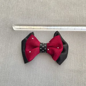 Handmade red and black bow with rhinestones and polka dots measured with ruler