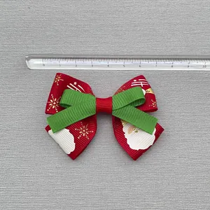 Close-up of 8.5cm red Christmas ribbon bow with Santa Claus and snowflake patterns