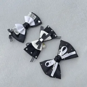 Detail of black and white ribbon bows with lace, pearls, and rhinestones for DIY accessories